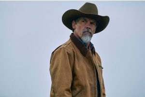 Josh Brolin gazes into the distance against a clear blue sky backdrop in "Outer Range" Season 1.