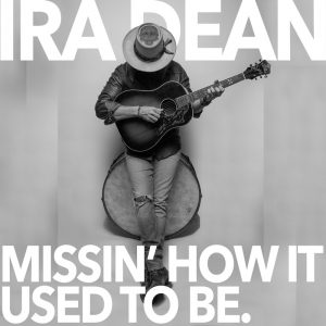 An image of Ira Dean leaning against a drum strumming a guitar with text reading "Ira Dean" above his head and text reading "Missin' How It Used To Be" below him.