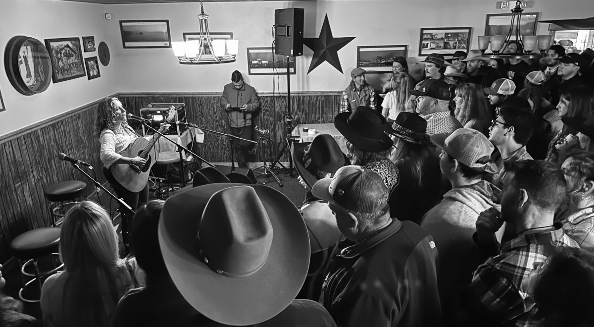 Caitlyn Taussig performing at 2024 Elko's Outside Circle to a crowd.